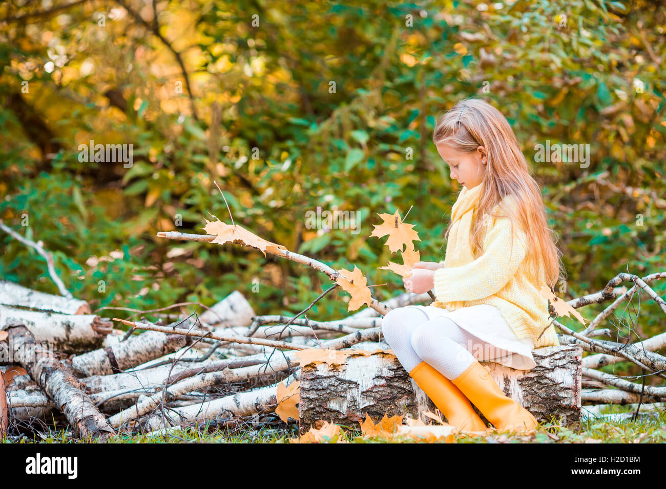 Little cute girl playing with leaves in autumn park outdoors Stock ...