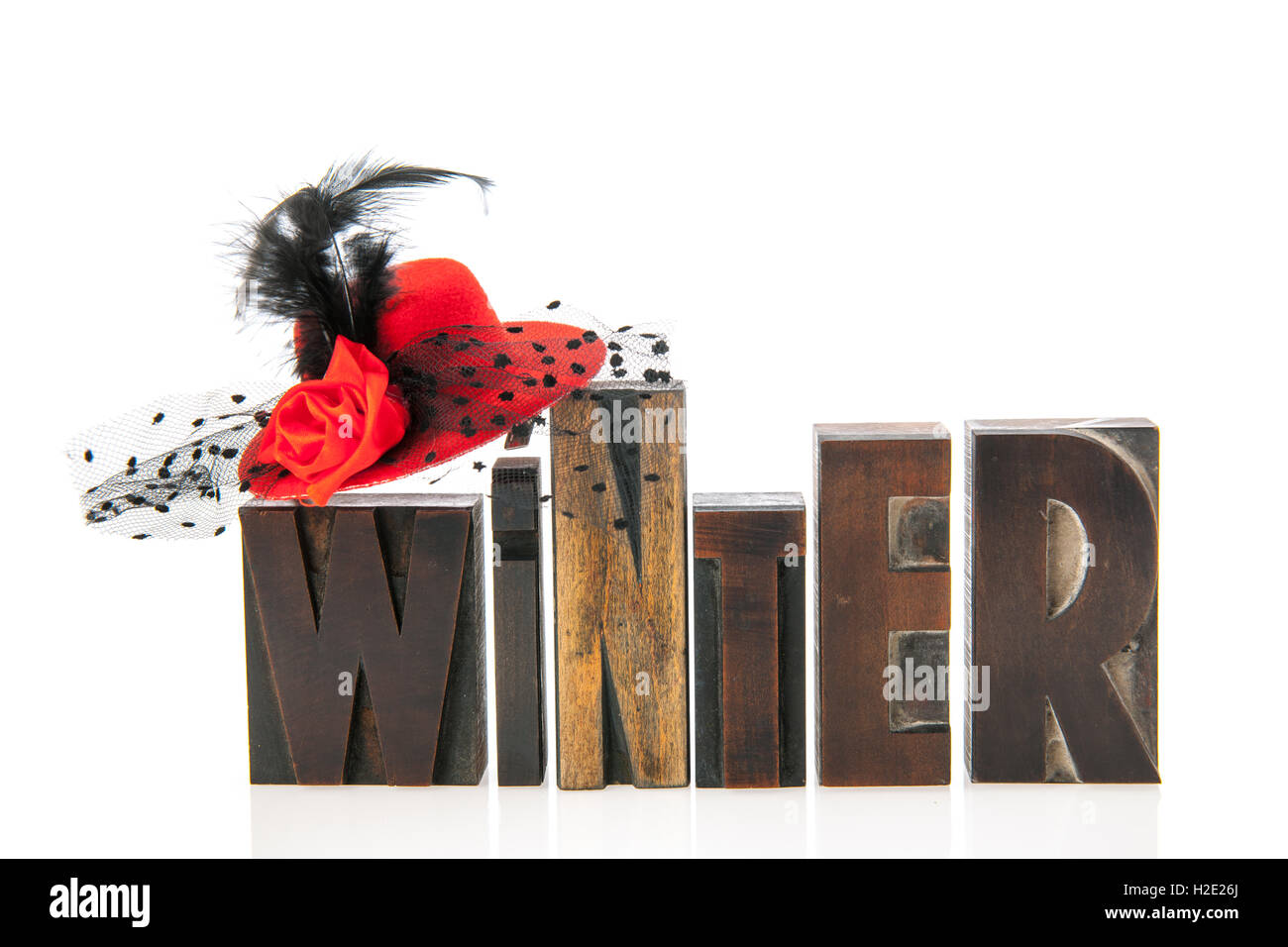 Winter in vintage text with female red hat Stock Photo