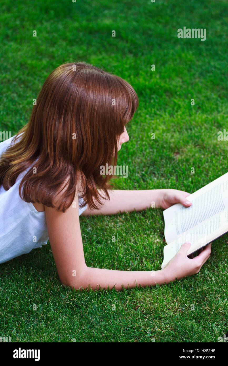 One.Young beautiful girl reading a book outdoor Stock Photo - Alamy