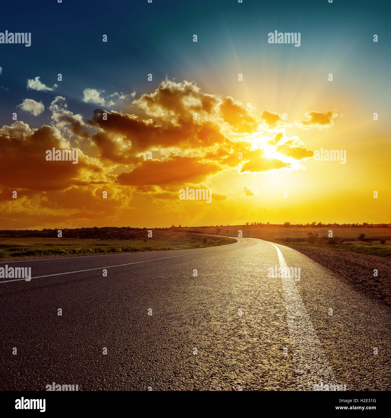 orange sunset over asphalt road Stock Photo - Alamy