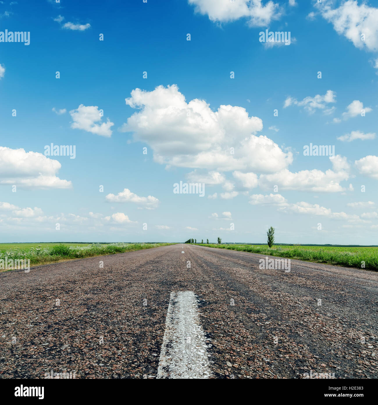 asphalt road close up under clouds in blue sky Stock Photo - Alamy