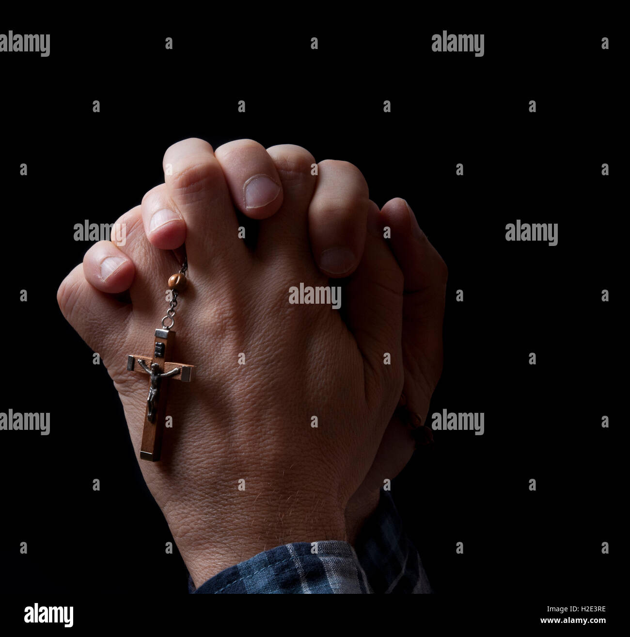 man's hands with rosary, praying Stock Photo