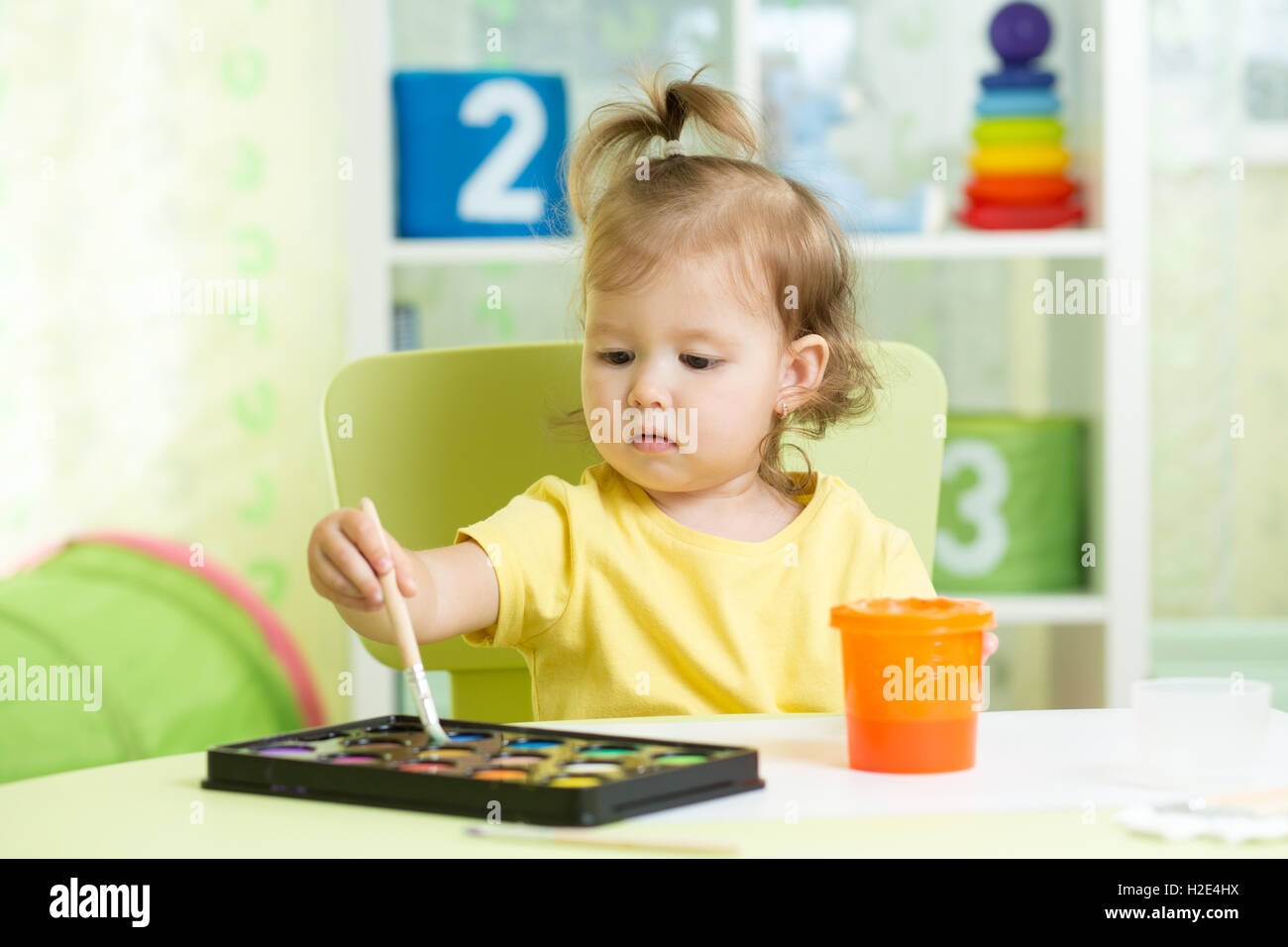 Child girl painting with watercolors at home or school nursery Stock ...