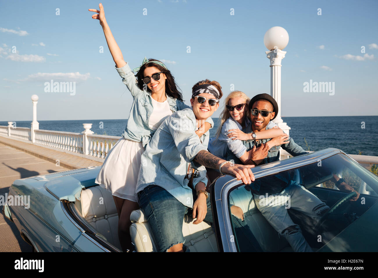 Group of cheerful young friends driving car outdoors Stock Photo - Alamy