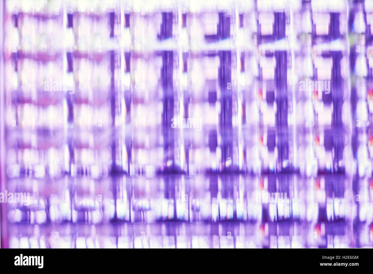 Blurred photo of purple glass block, abstract background. Stock Photo