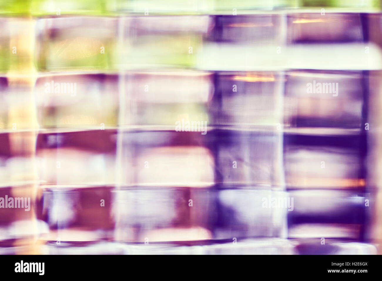 Blurred photo of glass block, abstract background. Stock Photo