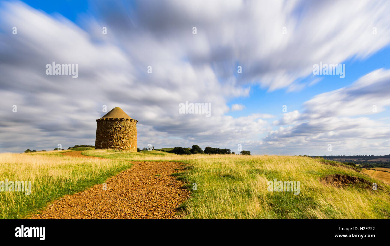 Beacon Tower stone monument on top of a hill in the British countryside in summer / autumn with beautiful cloud formations Stock Photo