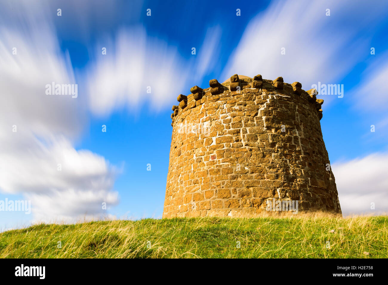 Beacon Tower Stone monument on top of a hill in the British countryside in summer / autumn with beautiful cloud formations Stock Photo