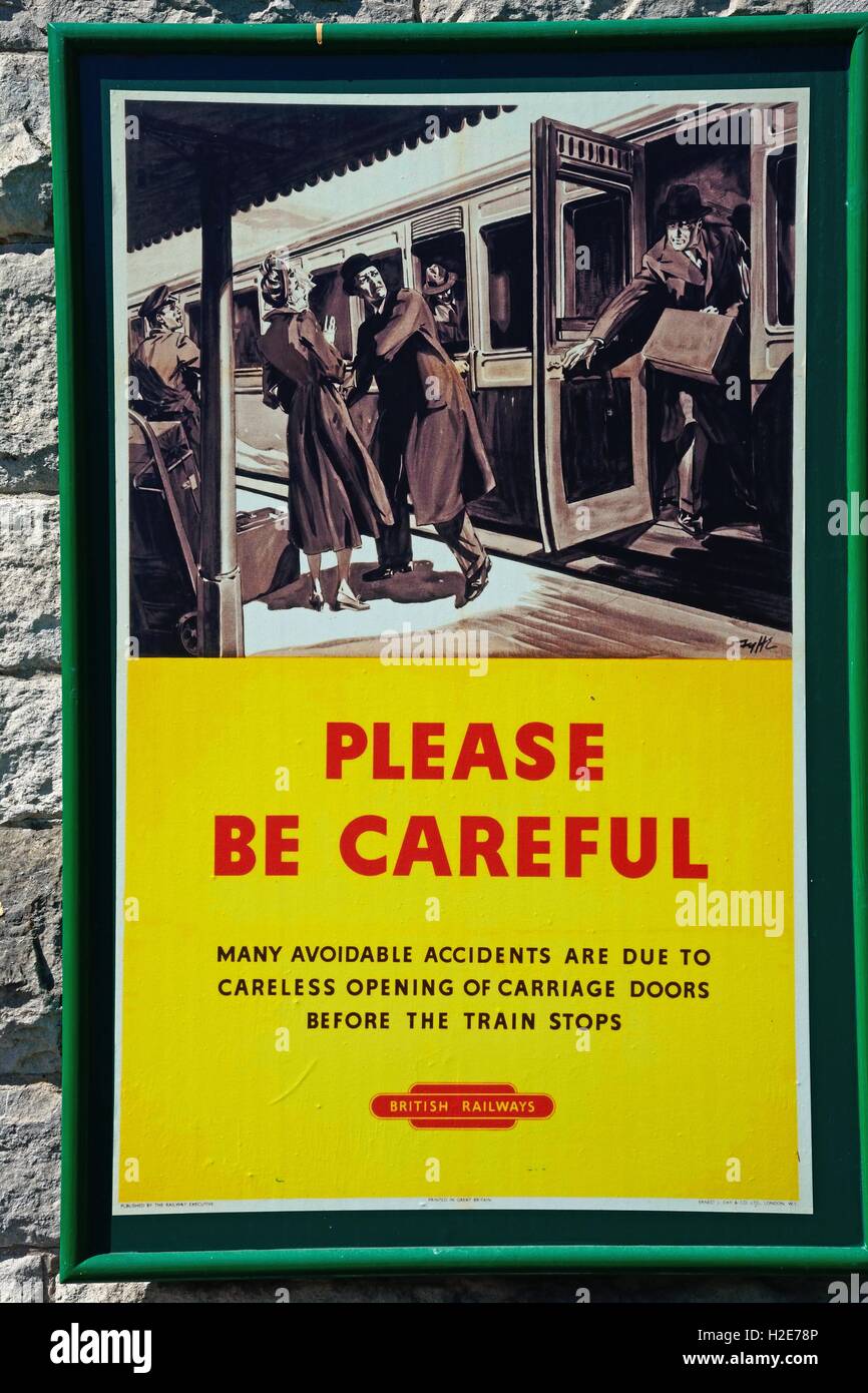 Old fashioned British Railways Be Careful poster at the railway station, Corfe, Dorset, England, UK, Western Europe. Stock Photo
