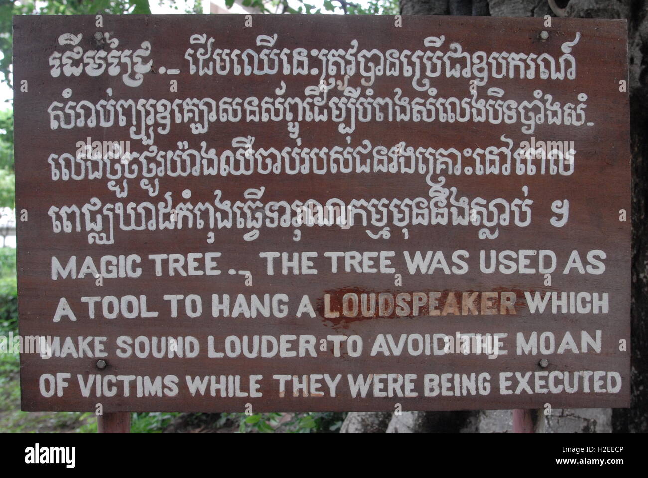 'Magic Tree' handwritten bilingual wooden sign, The Killing Fields, Choeung Ek Genocide Memorial, Phnom Penh, Cambodia. credit: Kraig Lieb Stock Photo