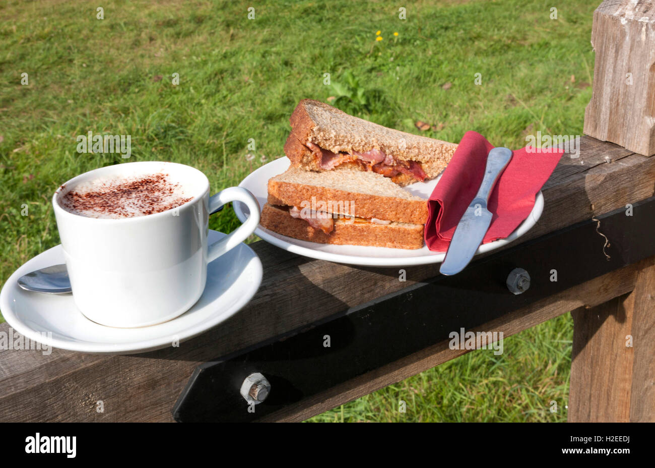 Bacon sandwich and cappuccino coffee on a farm gate Stock Photo Alamy