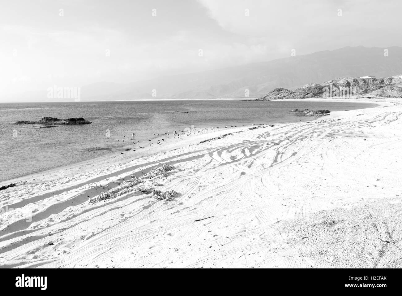 near sandy beach sky and mountain in oman arabic sea Stock Photo - Alamy