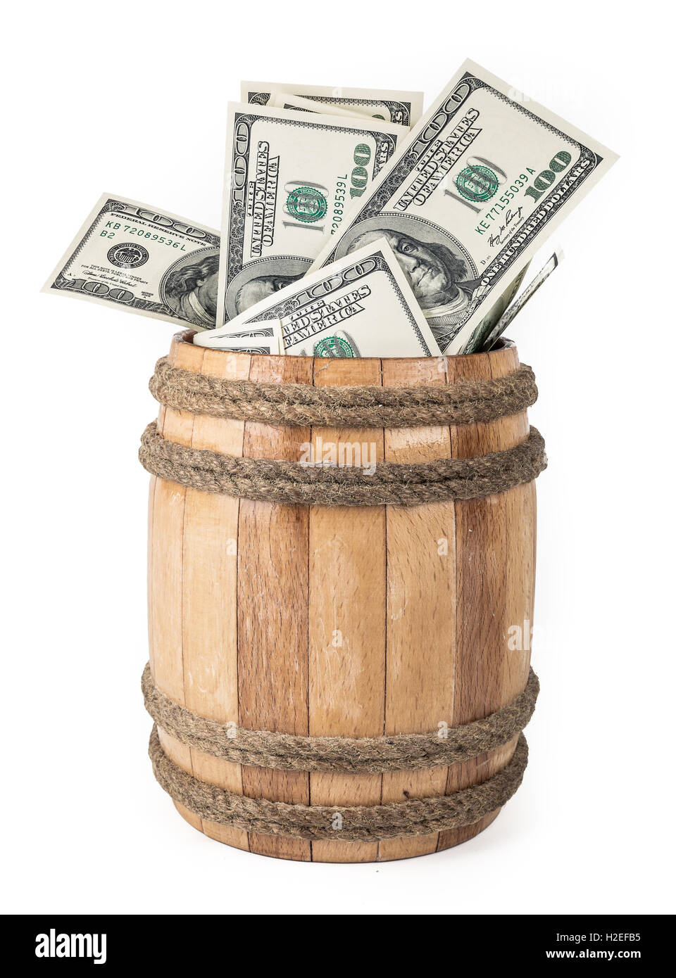 Wooden barrel with hundred dollar bills Stock Photo