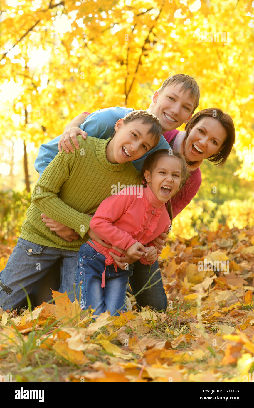 Family relaxing in autumn park Stock Photo - Alamy