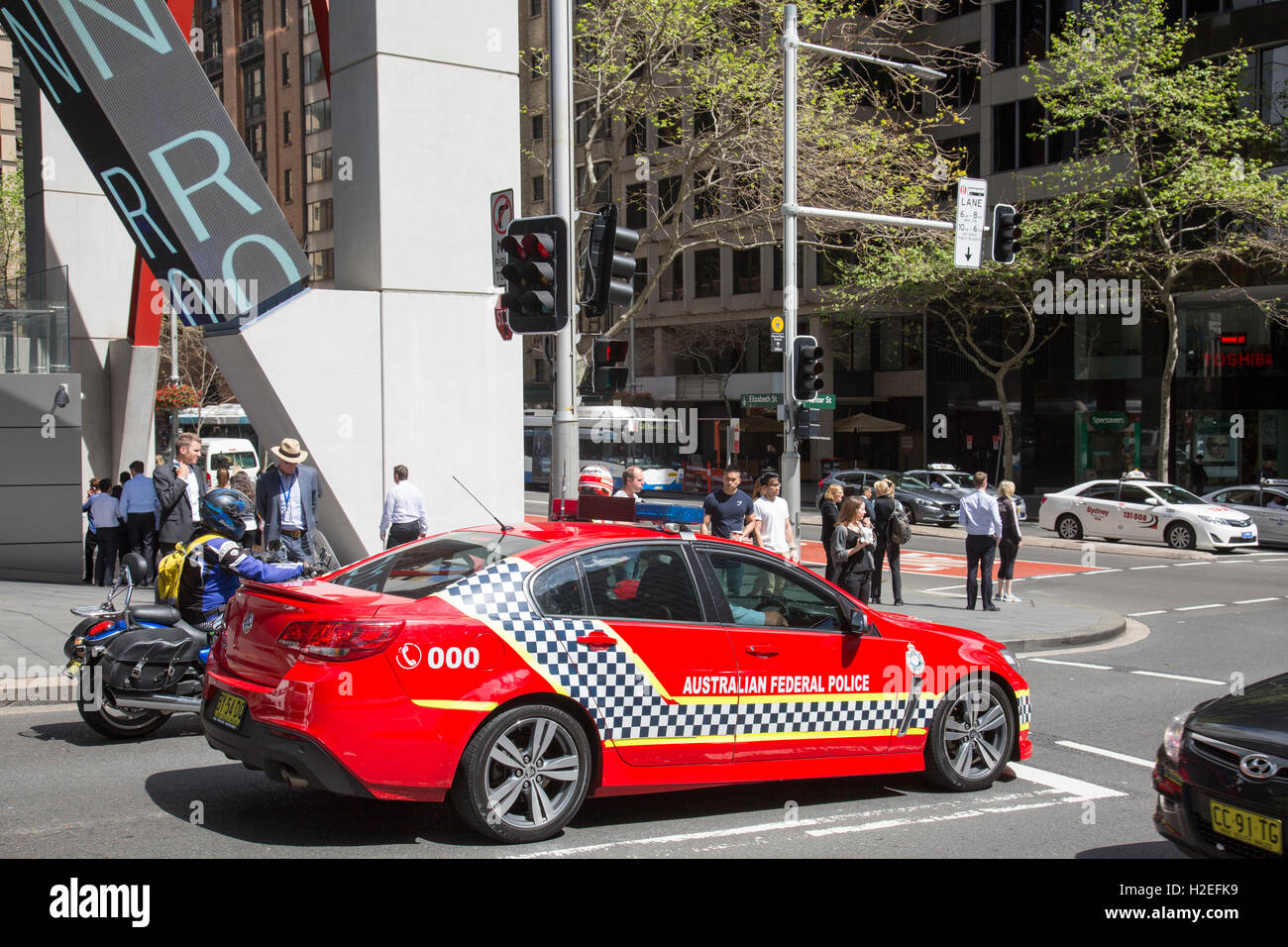 Australian Federal police AFP officers in a marked red police car in Sydney city centre, NSW, Australia Stock Photo