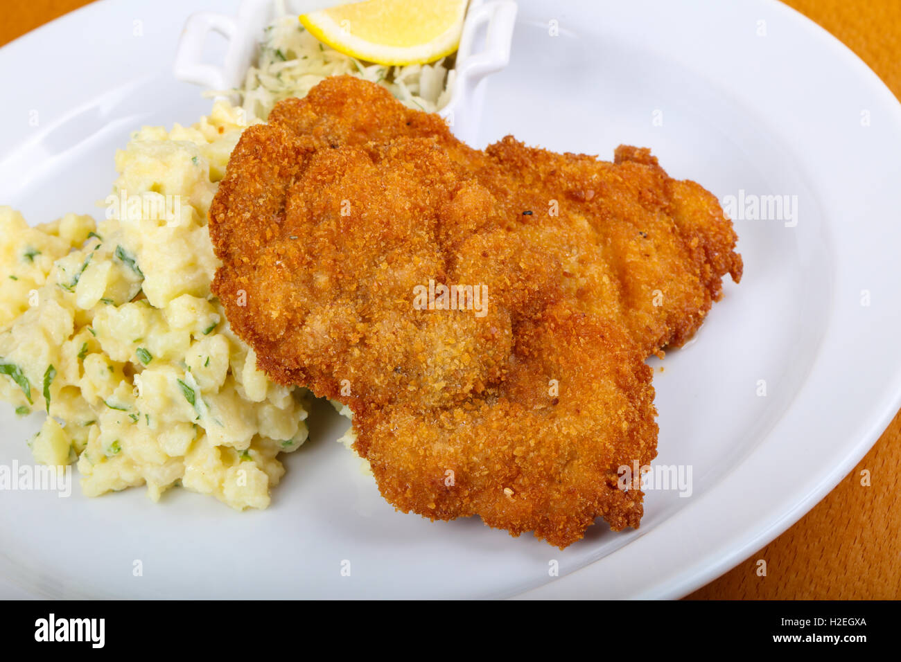 Czech cuisine - schnitzel with cabbage and lemon Stock Photo - Alamy