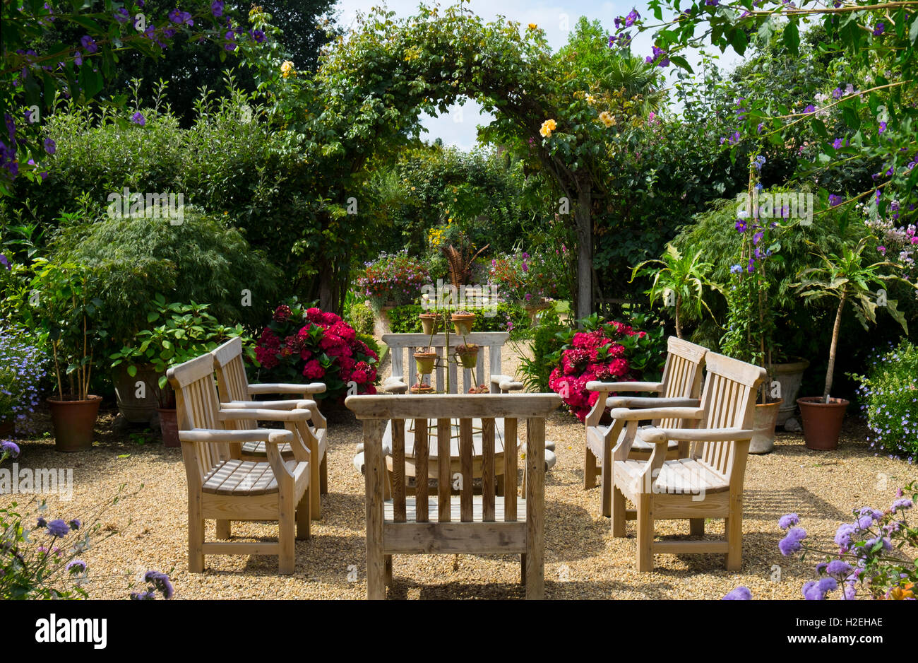 Wooden table and chairs, Old Vicarage Gardens, East Ruston, Norfolk, UK Stock Photo