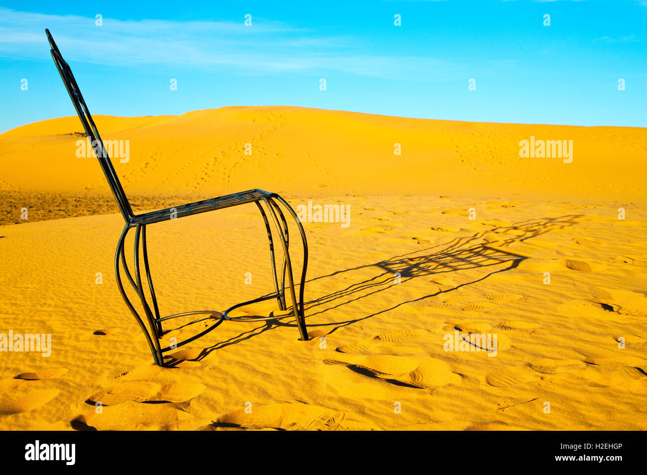table and seat in desert sahara morocco africa yellow sand Stock Photo