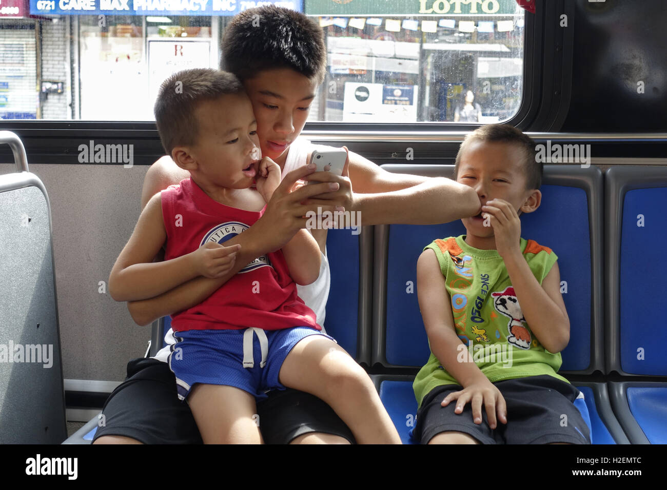 Brothers ride the bus together in Brooklyn, NY Stock Photo Alamy