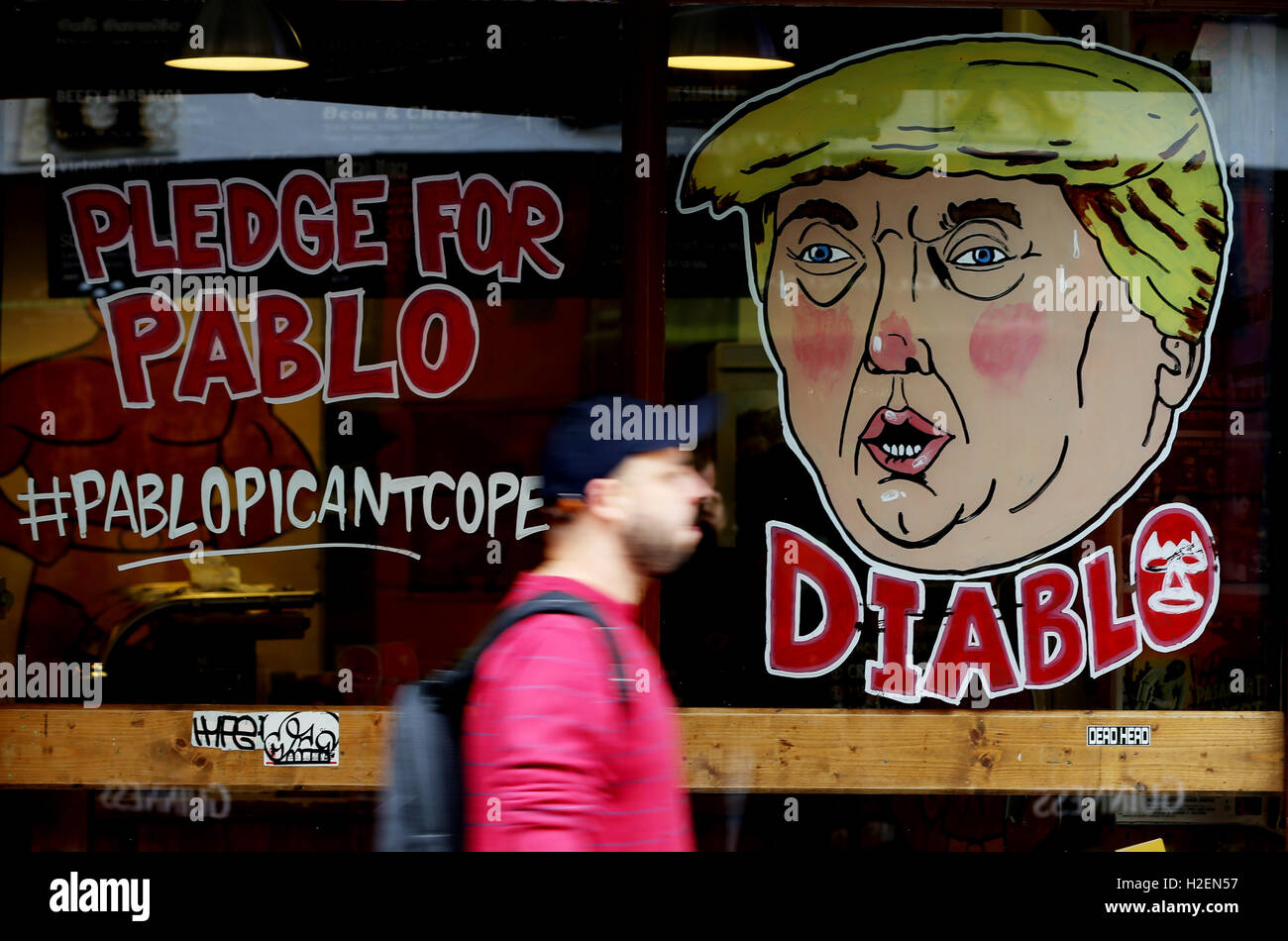 A caricature of US presidential candidate Donald Trump with the word 'Diablo' (Devil) is seen in the window of a burrito shop in Dublin's Temple Bar the day after he clashed with Democrat rival Hillary Clinton in their first head-to-head debate in the race to the White House. Stock Photo