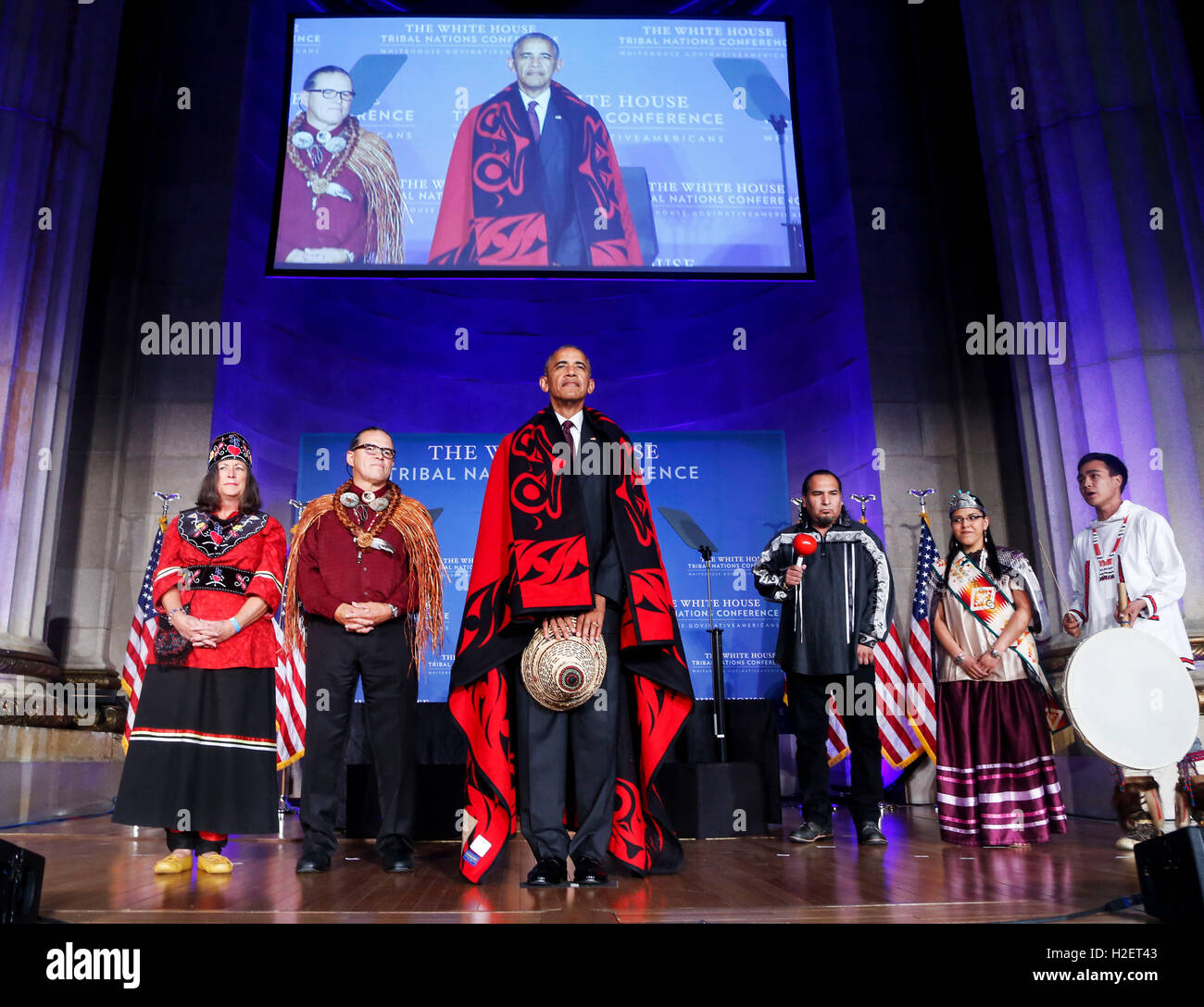 US President Barack Obama receives a traditional blanket and hat during