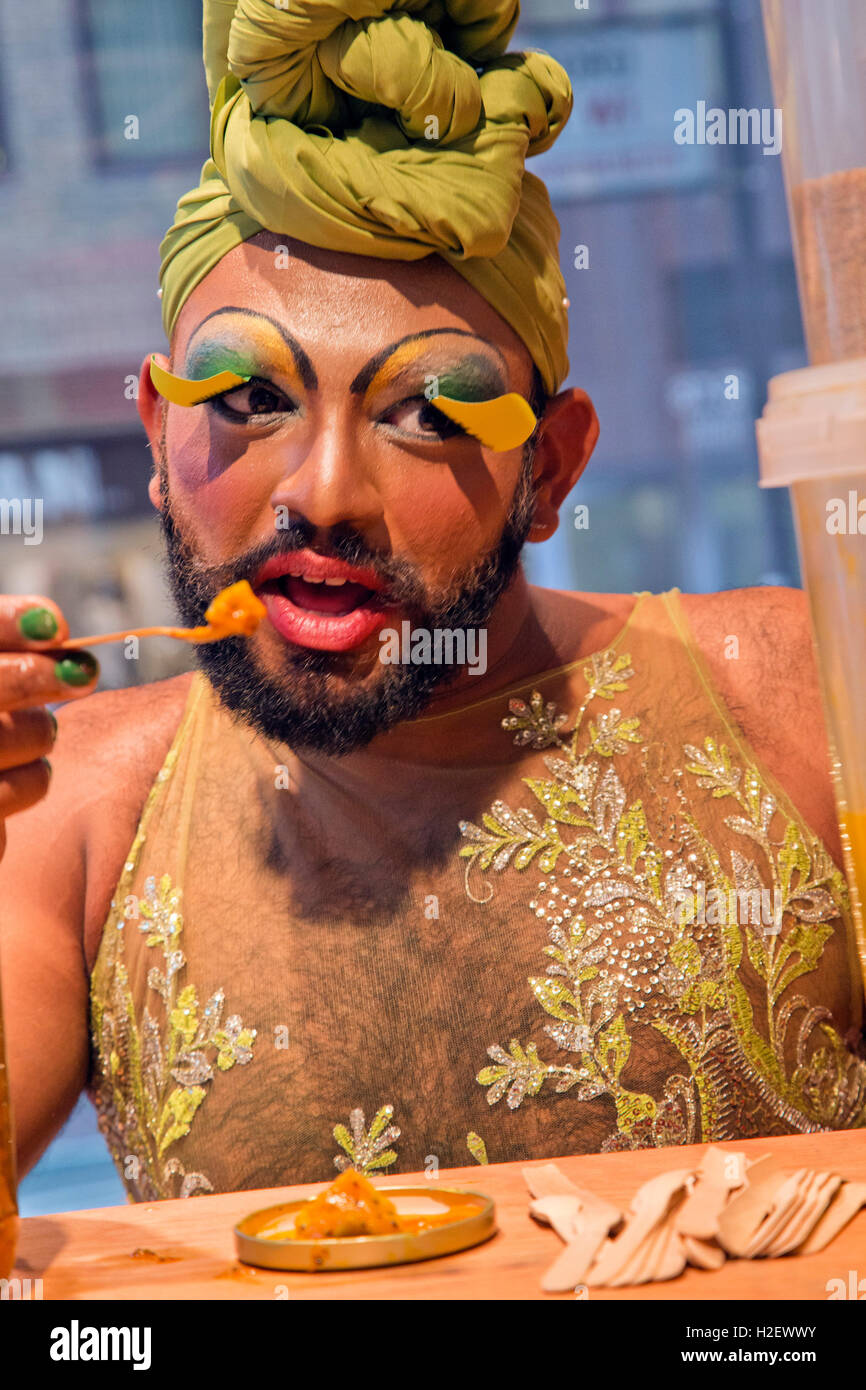 Rhada La Bia, a performance artist tasting spicy lime pickles and publicizing 'Midnight Masala' in the Empire Remains Shop 91-93 Baker Street London W1, England, UK Stock Photo
