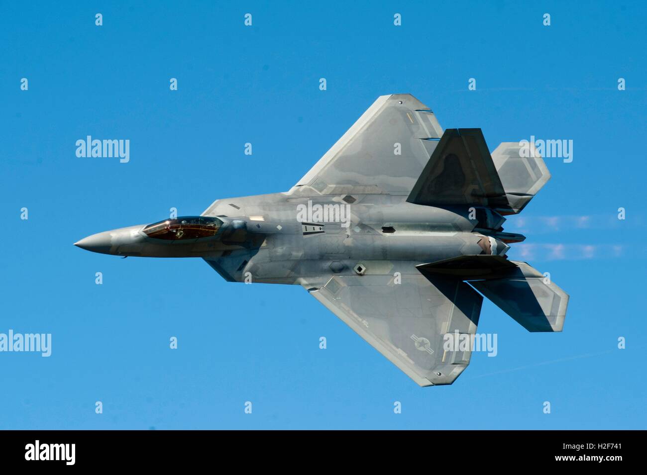 A U.S. Air Force F-22 Raptor stealth fighter aircraft performs aerial maneuvers during a demonstration for the AirPower over Hampton Roads Open House at the Langley Air Force Base April 24, 2016 in Hampton, Virginia. Stock Photo