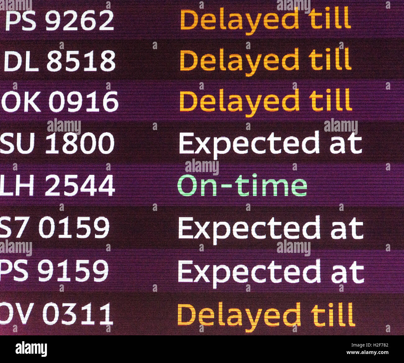 International arrivals board panel. Delays and timely arrival Stock