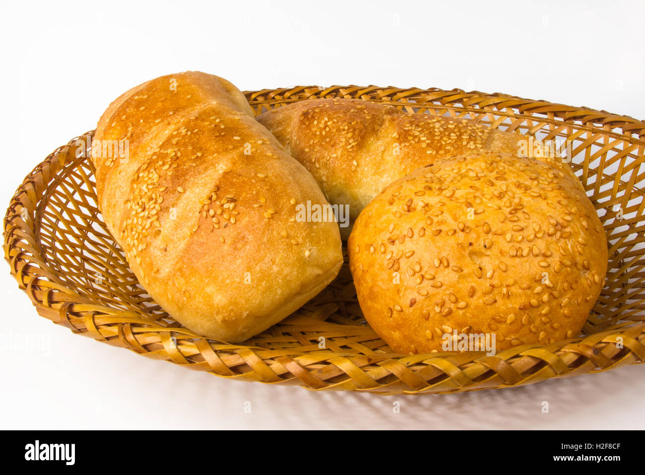 whole wheat breads and bun on a wicker plate Stock Photo - Alamy