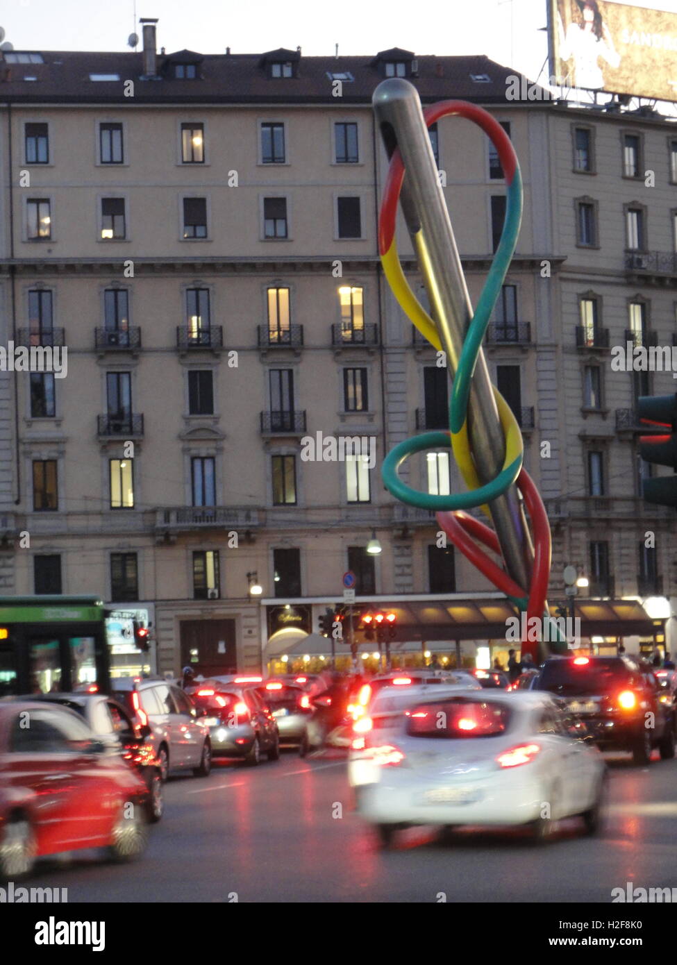 milan by night with traffic, Cadorna Station, 'Ago e filo' sculpture by the famous artist Claes Oldenburg Stock Photo