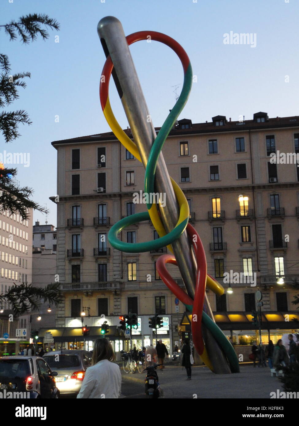 milan by night with traffic, Cadorna Station, 'Ago e filo' sculpture by the famous artist Claes Oldenburg Stock Photo