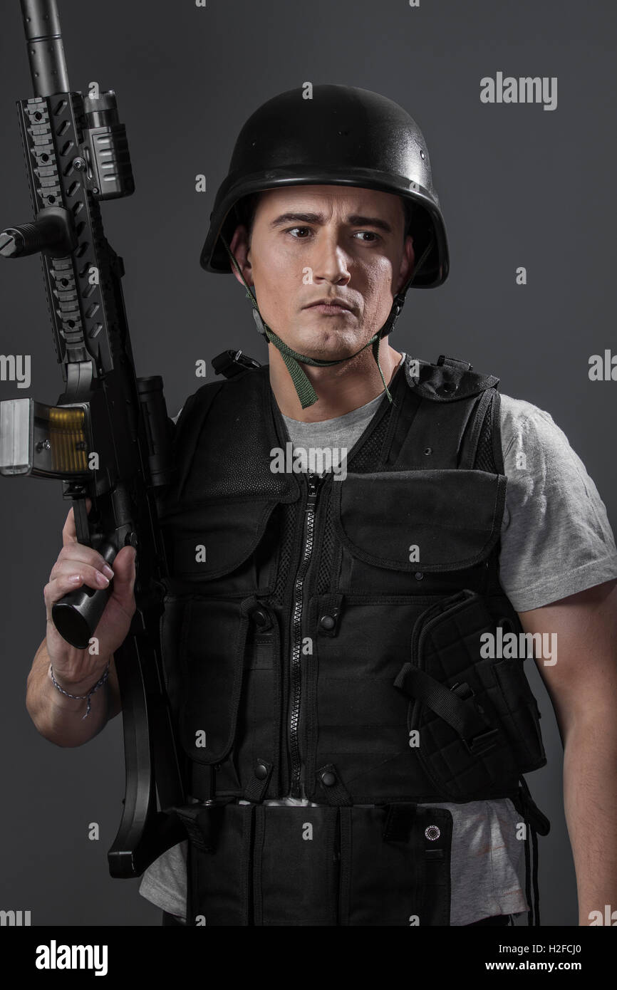 paintball sport player wearing protective helmet aiming pistol Stock