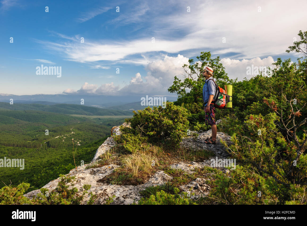 Hiking man in rays of sunset Stock Photo