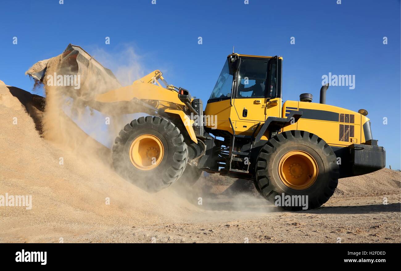 Front End Loading Digging in Sand Stock Photo