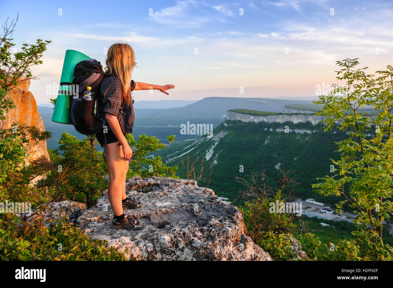 Hiking woman in rays of sunset Stock Photo