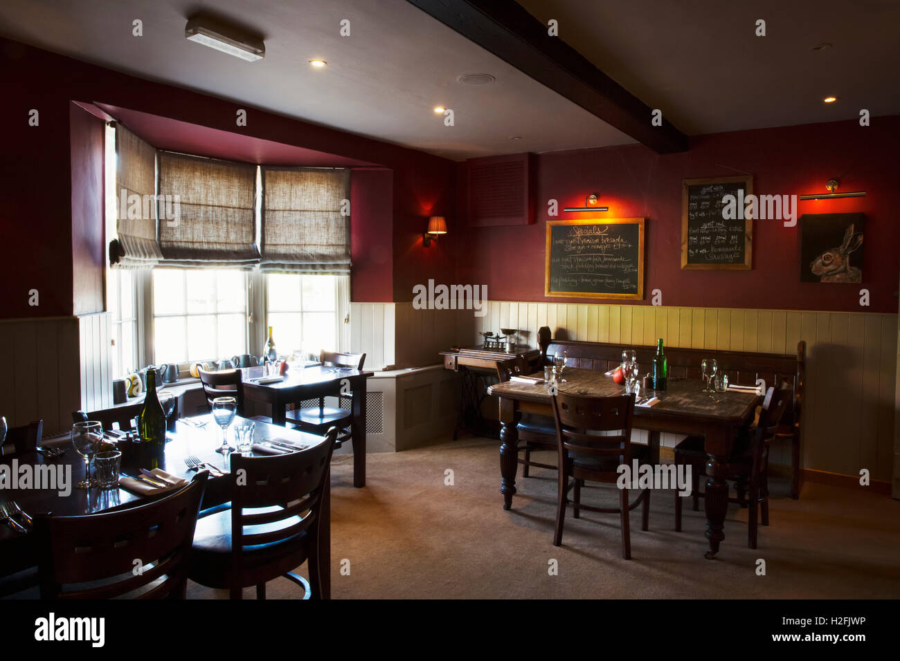 Village public house interior. Tables laid for dinner. Stock Photo