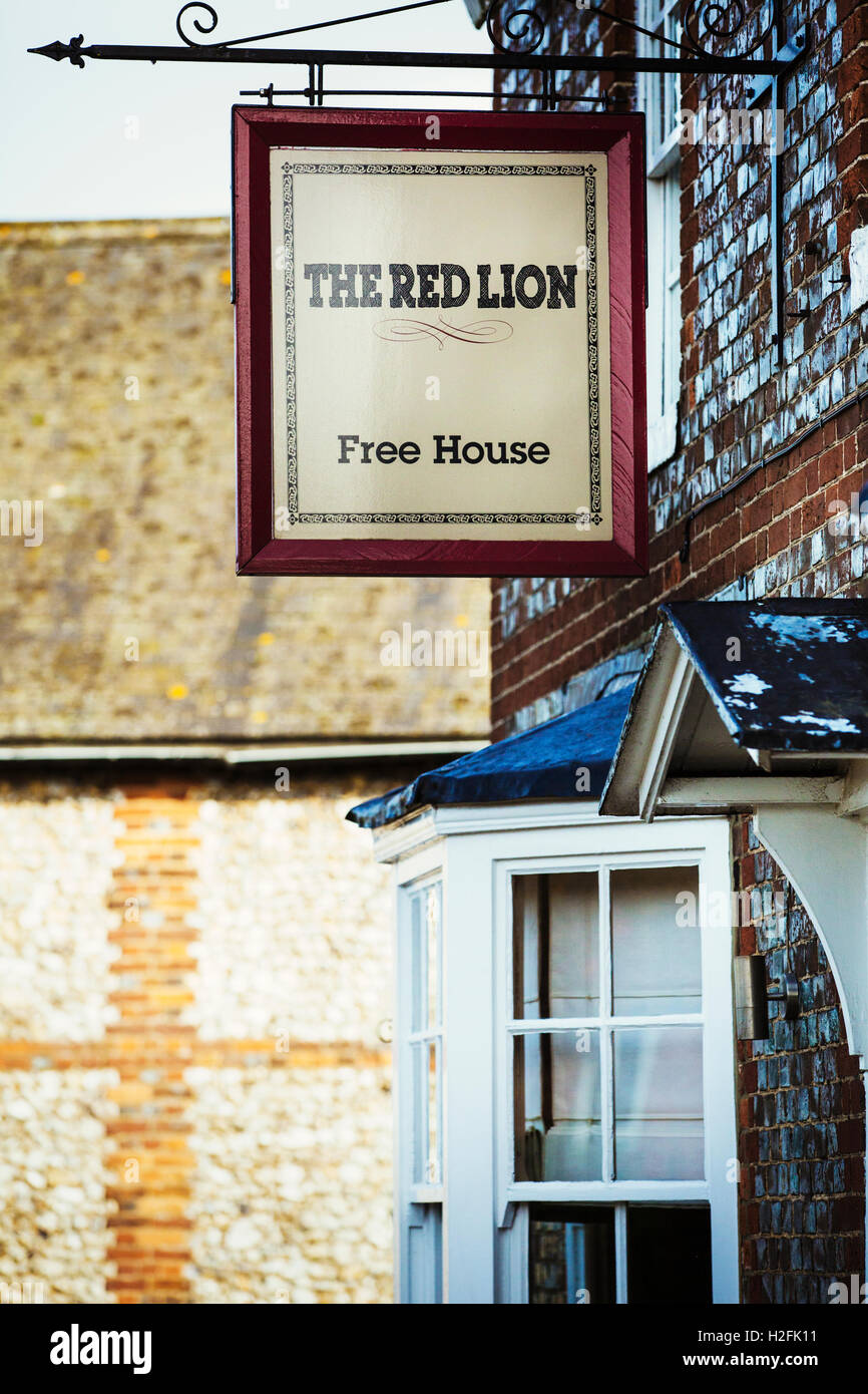 The Red Lion  village public house pub sign outside the local pub. Stock Photo