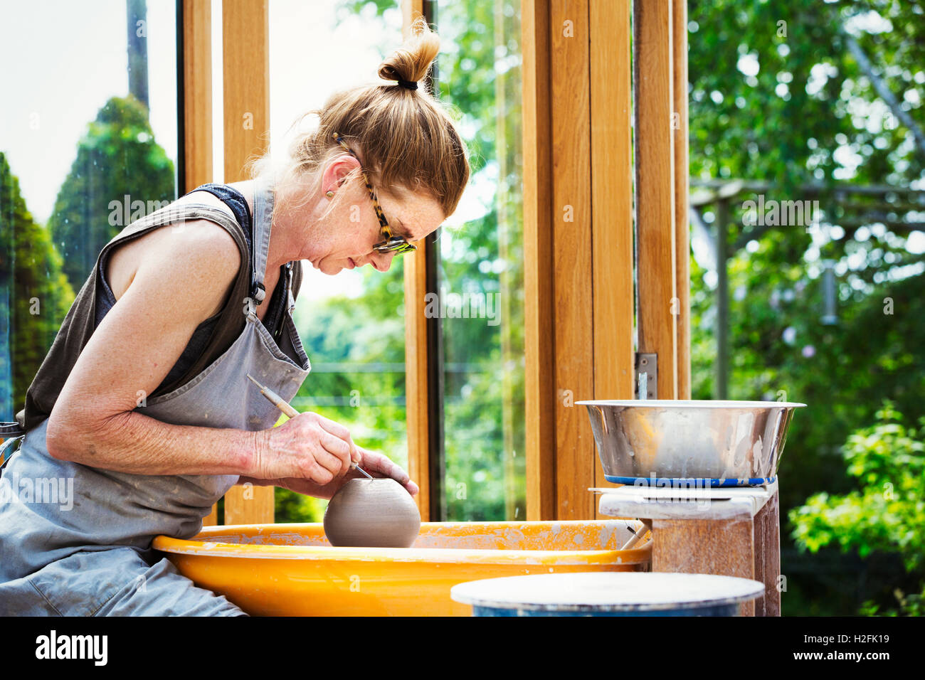 Premium Photo  Potter making a clay object on pottery wheel in outdoors  craftsman moulding clay with hands on potte