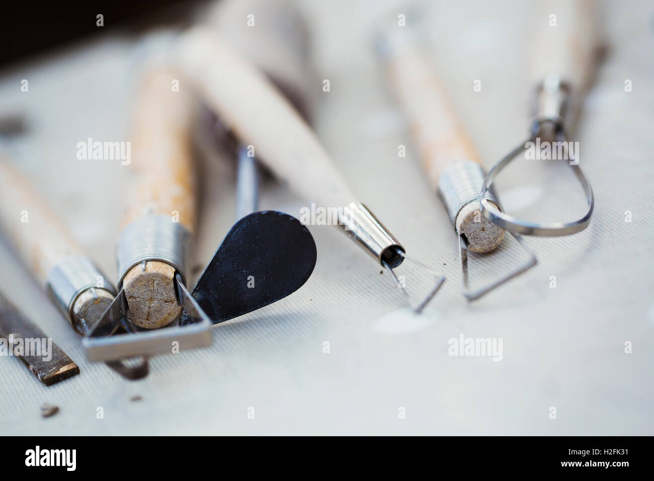 A row of hand tools for potters on  a workbench. Wire shaping tools. Stock Photo
