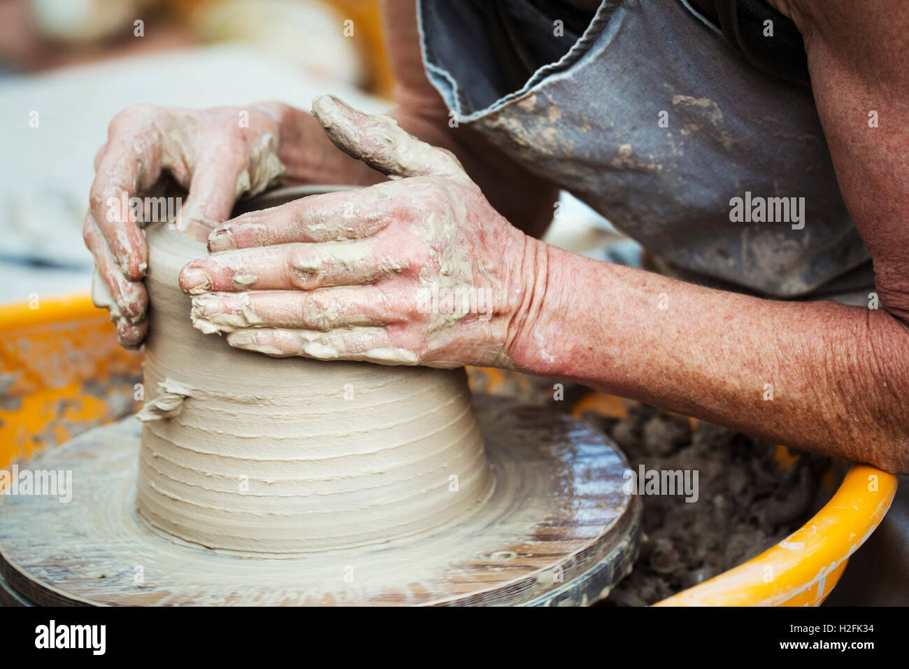A woman potter working clay on a potter's wheel in her workshop Stock ...