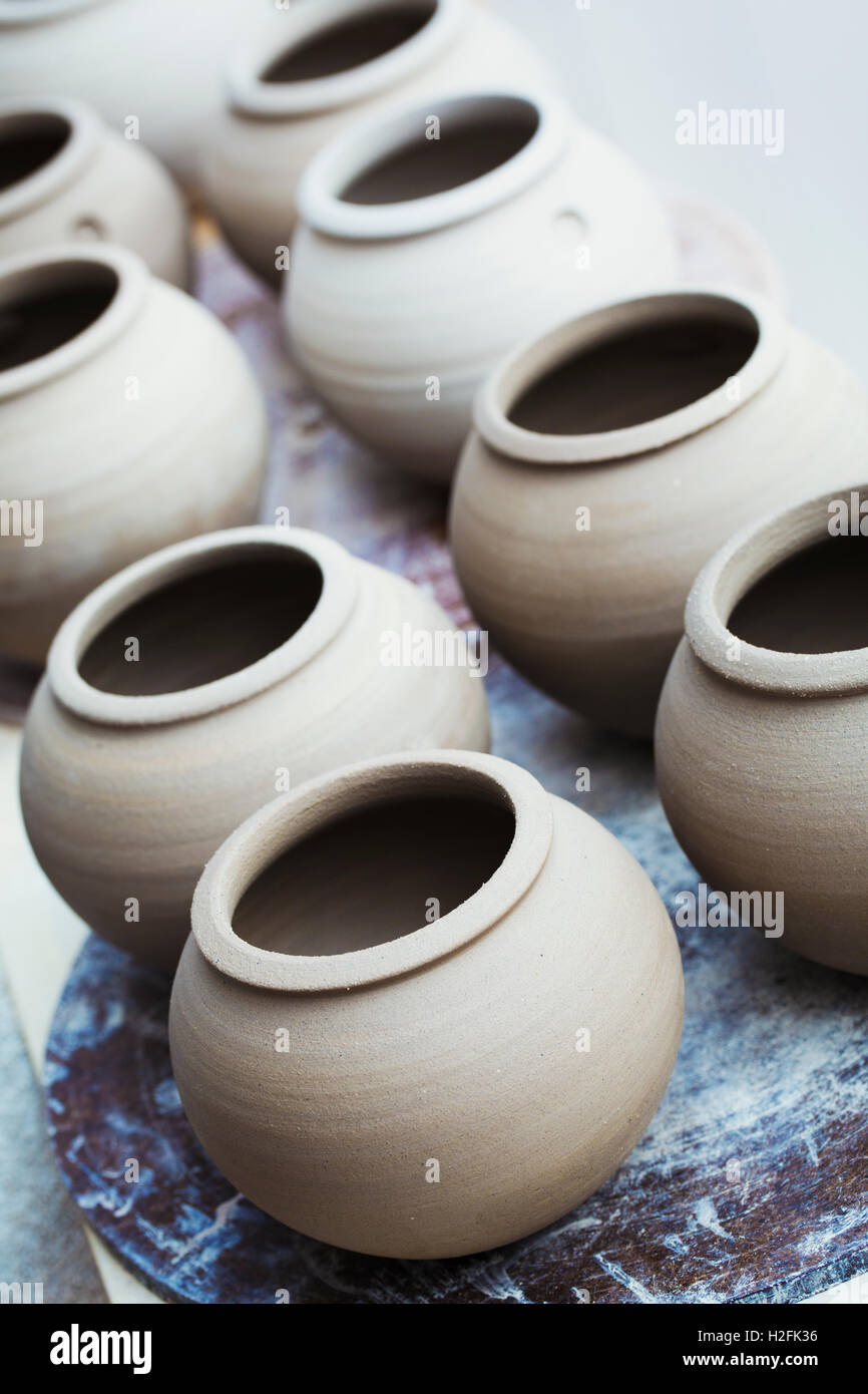 A row of handthrown pots, vases with round tops. Stock Photo