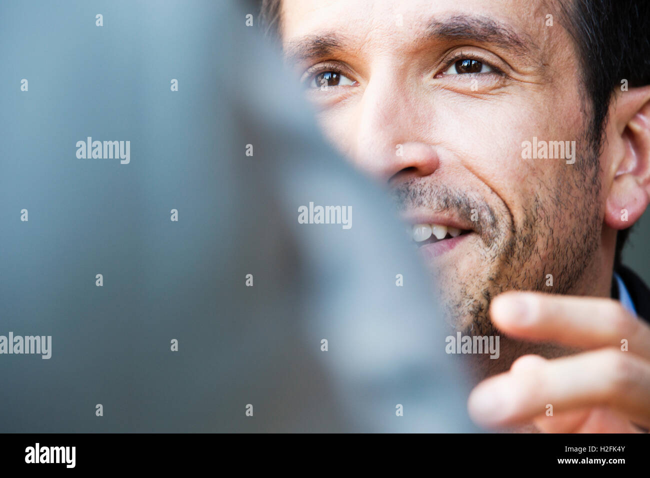 Close up of a smiling businessman, face partially obscured. Stock Photo