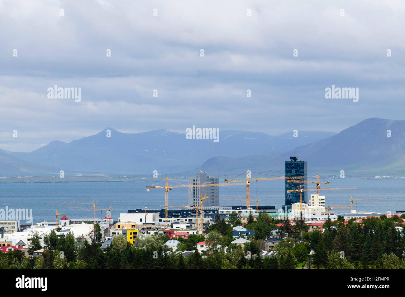 Cranes and new building developments seen from Öskjuhlíð hill. Reykjavik, Iceland Stock Photo