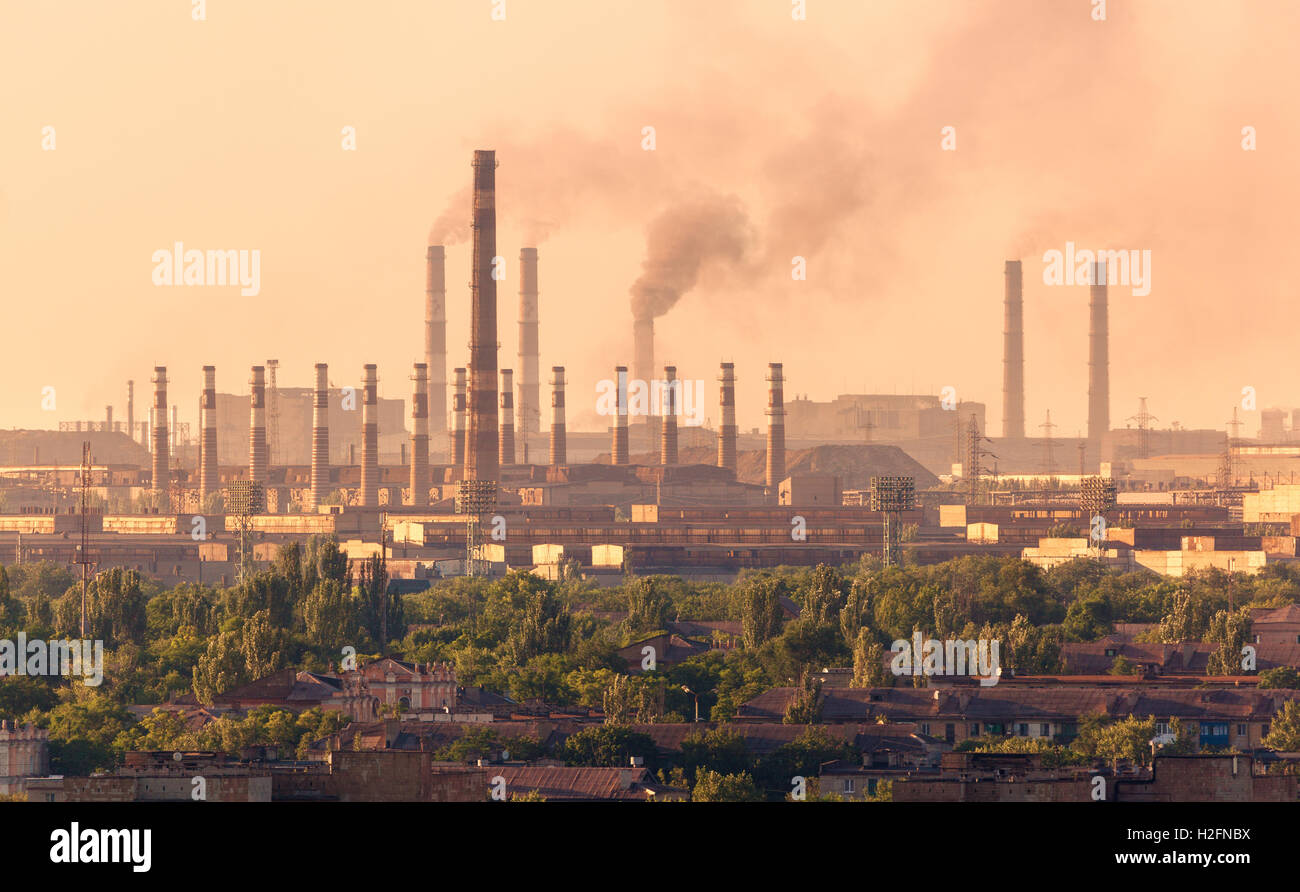 Steel mill, Metallurgy plant at sunset. Heavy industry factory. Steel factory with smog. Pipes with smoke. Metallurgical plant. Stock Photo