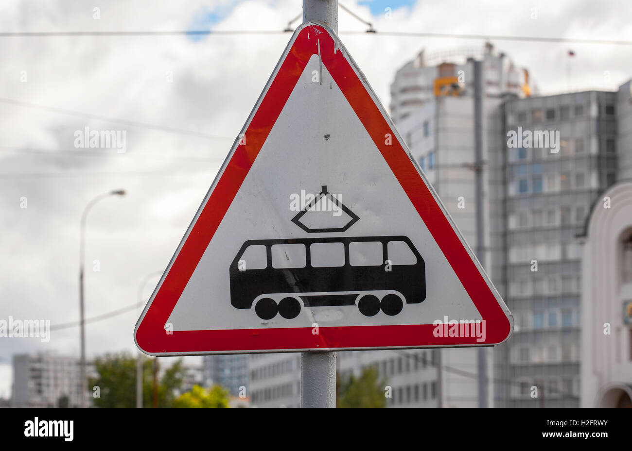Tram road sign. Blurred city in the background Stock Photo