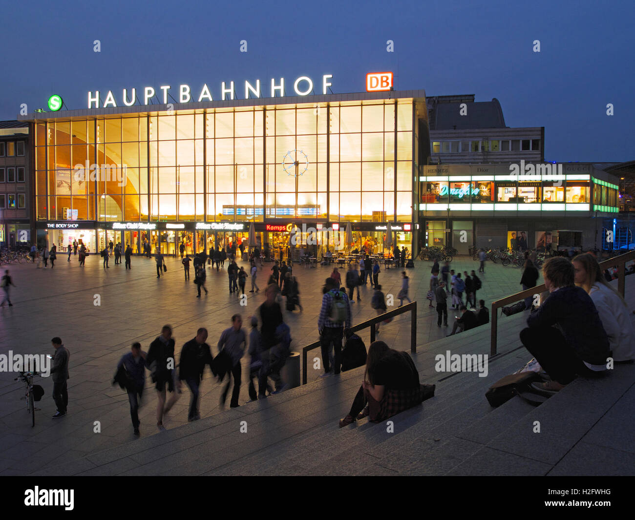 Cologne central station hauptbahnhof at night with many people on the square, Cologne, Germany Stock Photo
