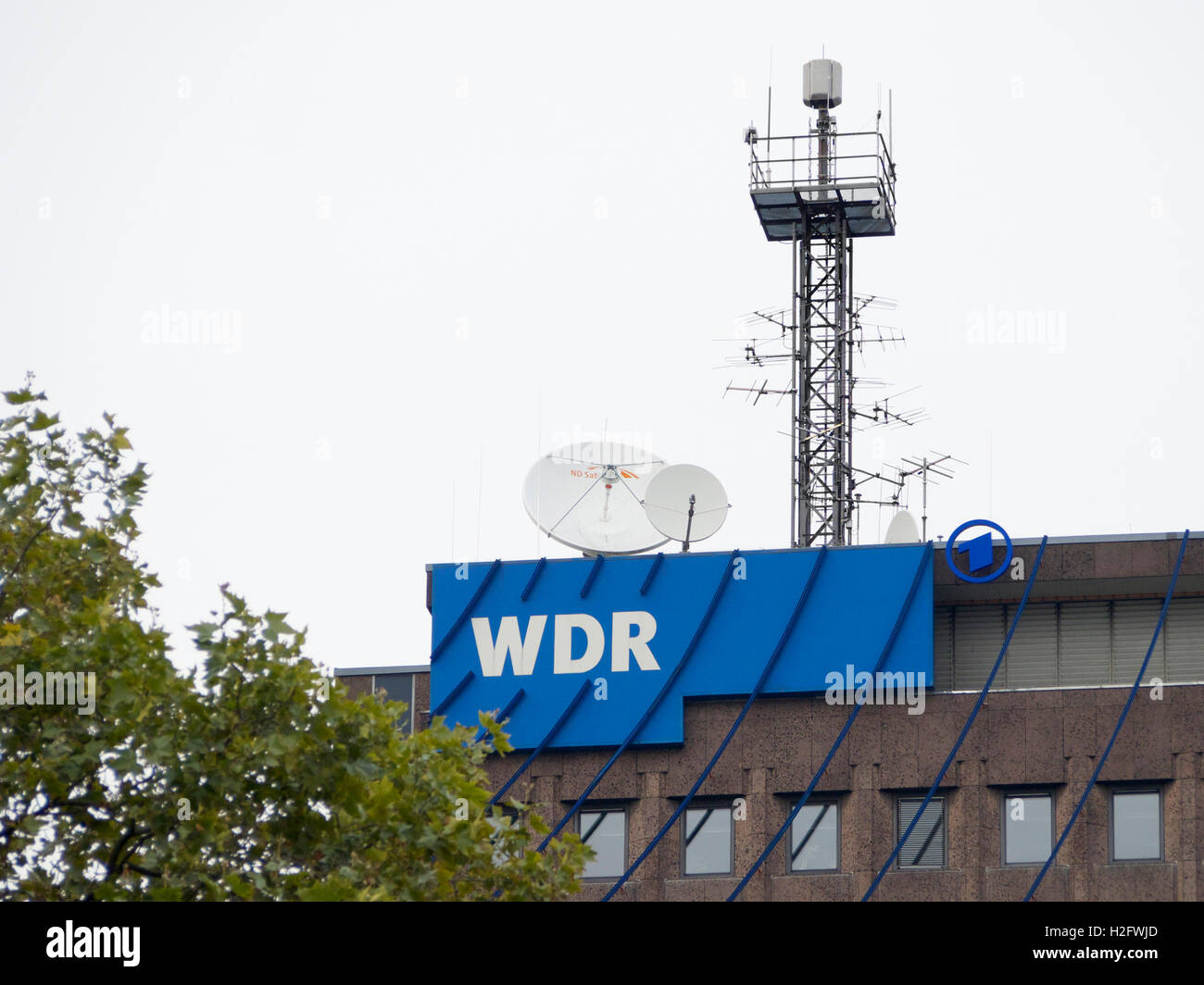 WDR west deutsche rundfunk TV station logo with satellite dishes and antenna tower. Cologne, Germany Stock Photo