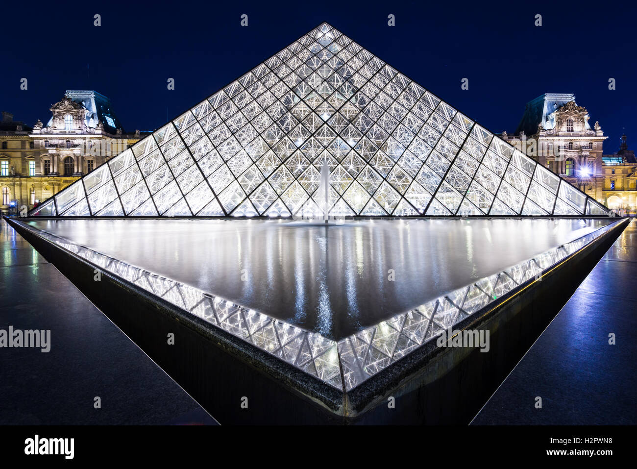 long exposure image of the Louvre Pyramid (Pyramide du Louvre) at night. The Pyramid was designed by I.M Pei Stock Photo