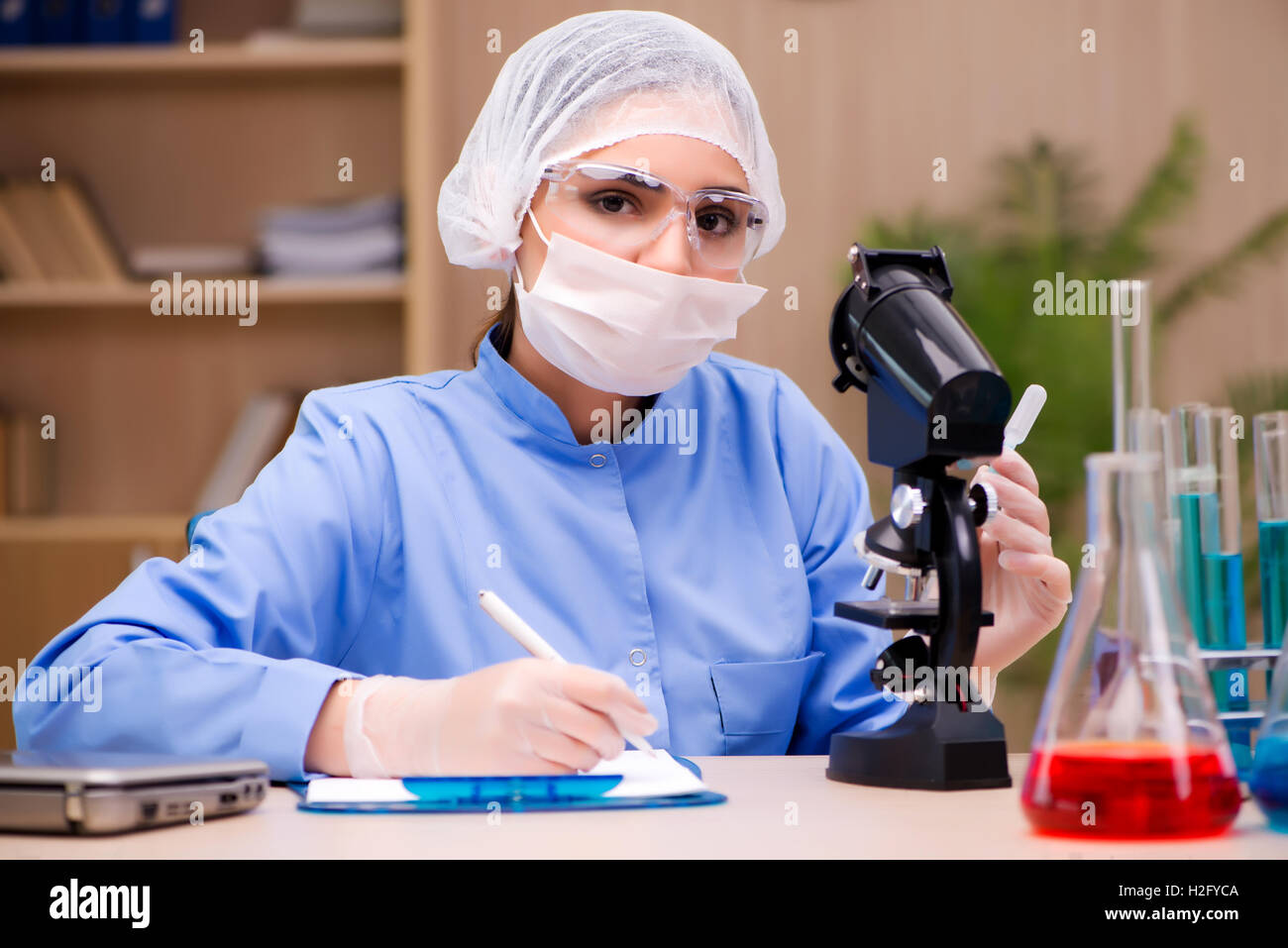 Microchemists Lab chemist working with microscope and tubes Stock Photo - Alamy