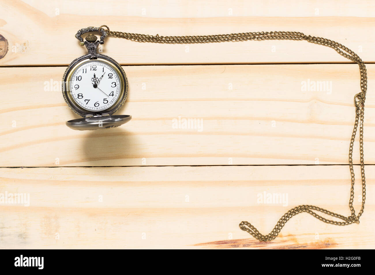 Top View Antique clock placed on a wooden floor. Stock Photo